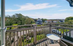 a view from the balcony of a house with a table and chairs at Stunning Apartment In Bohus-malmn With Wifi And 3 Bedrooms in Malmön