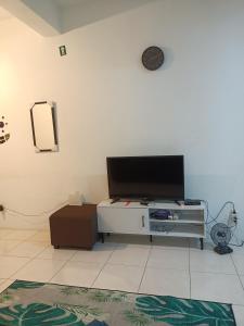 een woonkamer met een flatscreen-tv aan een witte muur bij 3rd floor apartment with 2 bedroom and no elevator in Kota Bharu