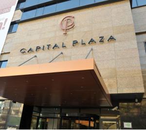 a building with the sign for a capital plaza at Capital Plaza Hotel in Bucharest