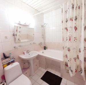 a bathroom with a sink and a toilet and a tub at "Золотой Квадрат" Центр Квартира - "Golden Square" Apart in Almaty +17 photos