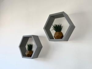 two gray pots with plants in them on a wall at Lovely Serviced Apartment - Near Doncaster Hospital in Doncaster