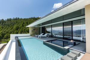 a house with a swimming pool with a view at ENOWA in Yufuin