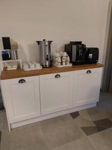 a kitchen counter with a coffee maker on top of it at Villa EDEN USTKA in Ustka