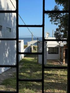a view from a window looking out at the ocean at Casa Alquiler Cuchilla Alta 2 in Cuchilla Alta +14 photos