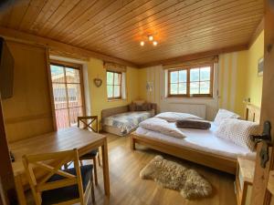 a bedroom with a large bed and a table at Apartments Golfweg in Kitzbühel