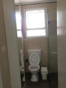 a small bathroom with a toilet and a window at Private Room in a Shared House-Close to City & ANU-2 in Canberra