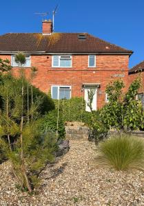 a brick house with a garden in front of it at Red Brick House in Yeovil