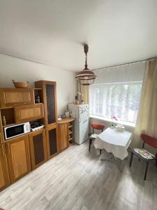 uma cozinha com uma mesa e um frigorífico branco em Lake hostel em Mustvee