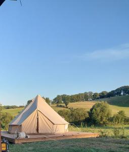 a large tan tent sitting in a field at Le Bunker du Houyeux in Herve