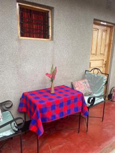 a table with a red and blue checkered table cloth at Livingstone Legacy Lodge in Arusha