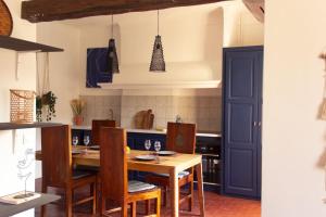 a kitchen with a wooden table and chairs at Casëto Luberon in Apt +39 photos