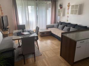 a living room with a couch and a table at Wohnhaus City Süd in Herzogsdorf