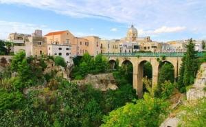 a bridge with a city in the background at B&B Il Rosone in Massafra