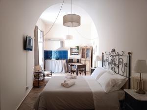 a bedroom with a bed with two towels on it at Spartivento Apartments in Matera