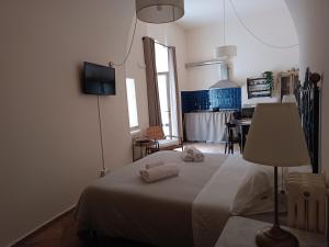 a bedroom with a bed with two towels on it at Spartivento Apartments in Matera
