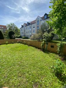 ein Hof mit einem Zaun und einigen Gebäuden in der Unterkunft Ferienwohnung Gartenoase in Dresden