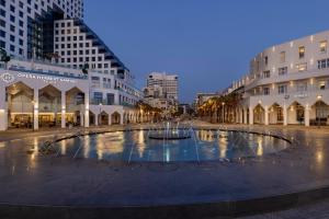 a large fountain in the middle of a city street at Herbert Samuel Opera Tel Aviv in Tel Aviv