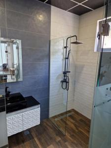 a bathroom with a shower and a sink at Стая Комфорт Пламен in Vratsa