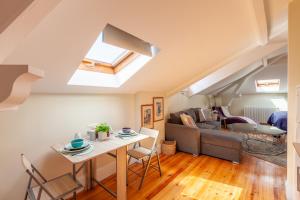 a living room with a table and a couch at Sky Accommodations Studio in Coimbra +37 photos