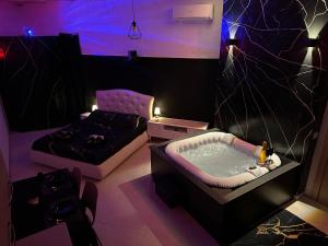 a room with a jacuzzi tub and a bed at Sassi di Matera Dimora Sovrana - Deluxe Suite in Matera