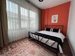 a bedroom with a bed and a red wall at The pillo loft in Istanbul