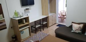 a small living room with a couch and a kitchen at LeBovallon B&B in Mahébourg