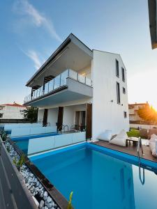 a house with a swimming pool in front of it at Sithon Diamond Suites 2 in Nikiti