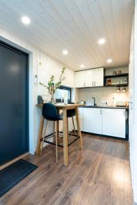 a kitchen with a wooden table and a chair at SHANTI FOREST HOUSE Guest house with mirror sauna 