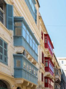 a building with blue and red balconies on it at Mulberry Suites in Valletta