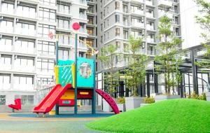 a playground in front of a tall apartment building at Sky Retreat Genting Highlands in Genting Highlands