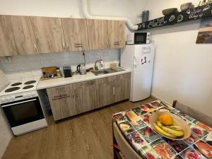 a kitchen with a table with a plate of fruit on it at GRAN hostel in Banská Bystrica