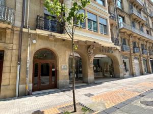 un pequeño árbol frente a un edificio en BUENPAS, en San Sebastián