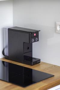 a black computer printer sitting on top of a counter at Bright Apartment in Ljubljana