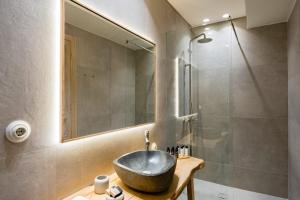 a bathroom with a sink and a shower at Eramai in Patra