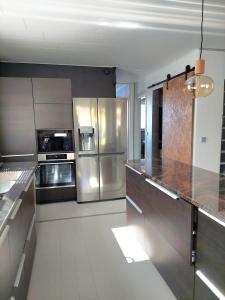 a kitchen with stainless steel appliances and granite counter tops at Ristimäenkatu in Mikkeli