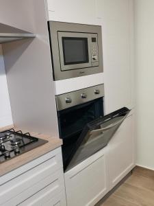 a kitchen with a stove and a microwave at Casa Marinella in Crotone