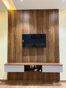 a flat screen tv on a wooden wall at Hotel iris in Nārnaul
