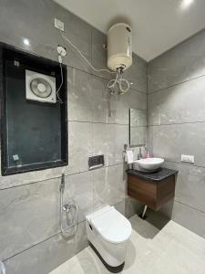 a bathroom with a toilet and a sink at Hotel iris in Nārnaul