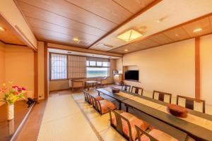 a conference room with a long table and chairs at 銚子グランドホテル in Choshi