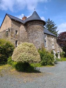 an old brick building with a chimney on top of it at Manoir normand du XIVe siecle. in Le Lorey