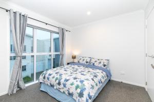 a bedroom with a bed and a large window at Comfy Stay Close to City Center in Hamilton