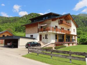 a house with a car parked in front of it at Ferienwohnung Eisl 2 in St. Wolfgang