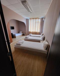 a hotel room with two beds and a television at Provans famili hotel in Lyetnitsa