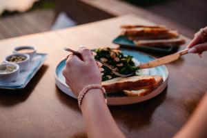 a person is eating a plate of food on a table at SECRET HILL in Athani