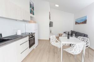 a kitchen with a table and chairs in a room at Ni-Ka in Pag