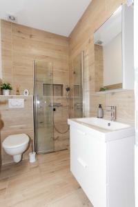a bathroom with a toilet and a sink and a shower at Ni-Ka in Pag +12 photos