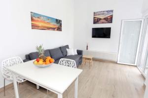 a living room with a white table and a couch at Ni-Ka in Pag