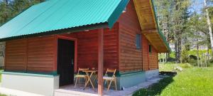 a small wooden cabin with a table and chairs outside at Apartman Djokovic in Žabljak
