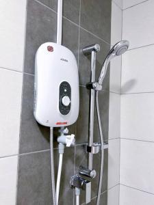 a shower with a soap dispenser in a bathroom at TheSun #Studio #BayanLepas #Pisa in Kampong Manggis