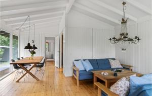 uma sala de estar com um sofá azul e uma mesa em 2 Bedroom Nice Home In Tisvildeleje em Tisvildeleje
